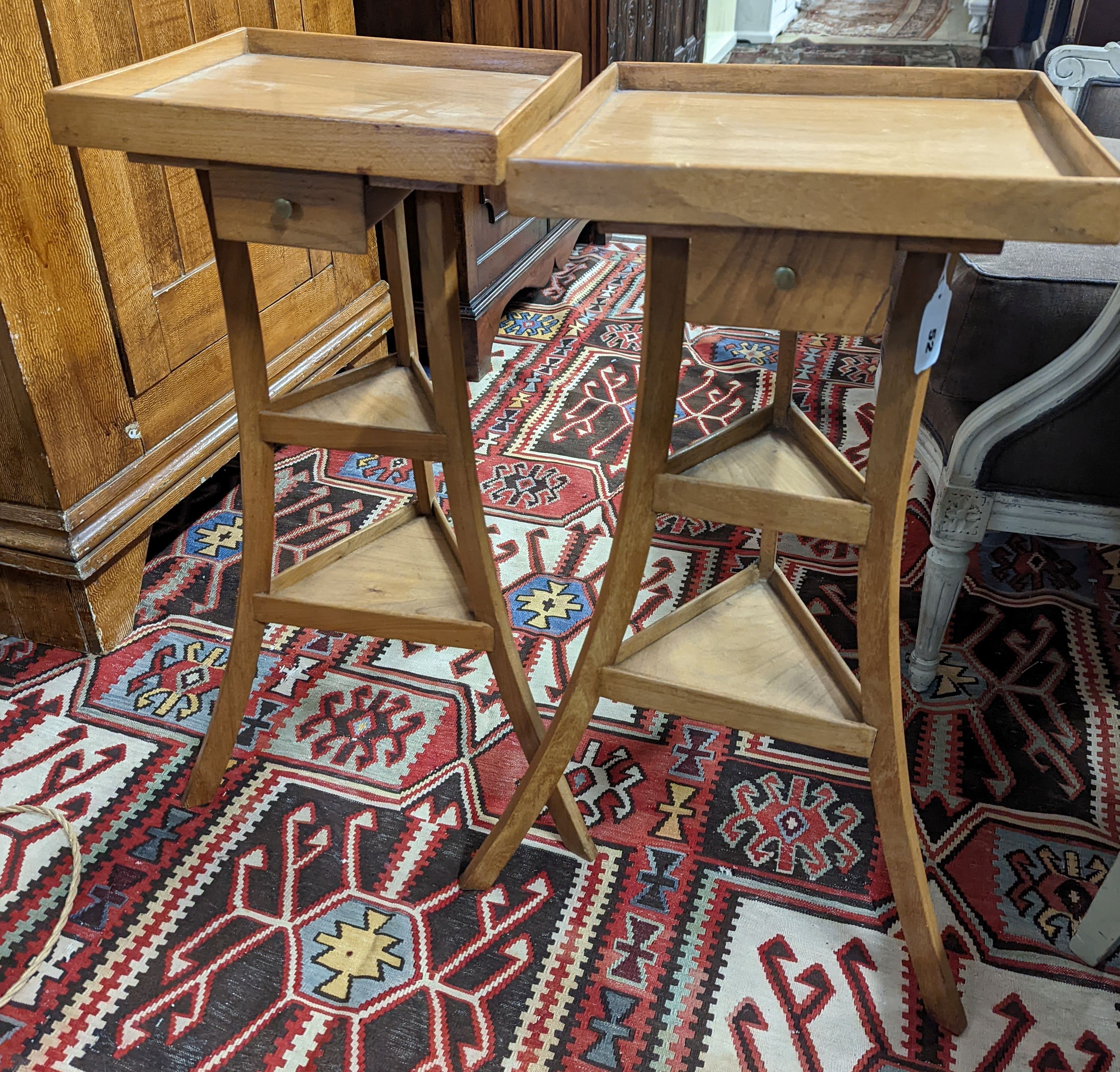 A pair of 1950's French design fruitwood square top three tier occasional tables, width 31cm, height 68cm